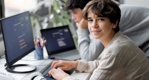 Boy with friends coding and STEM