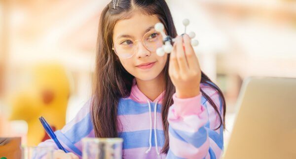 Young girl with science models in STEM
