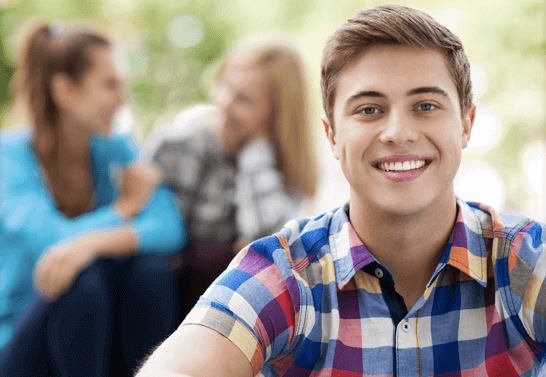 smiling high school boy participating in coding internship